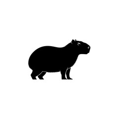 Obraz premium Black silhouette of a capybara standing in profile on a plain white background, representing a large rodent.