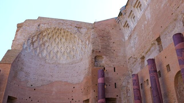 tall brick wall coffered semicircular vault worn purple red marble columns interior grand roman ruin rome italy reveals coffer purple-red 