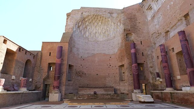 large ancient brick hall rome italy has coffered apse ceiling purple red marble columns scattered fragments ornate stone floor illuminated by daylight coffer purple-red 
