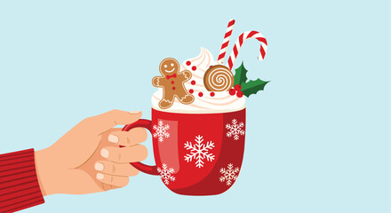 Hand holding a festive red Christmas mug of hot chocolate topped with whipped cream, a gingerbread man, and candy canes.
