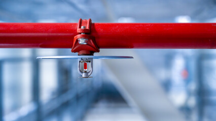 fire sprinkler on red fire pipe © venars.original