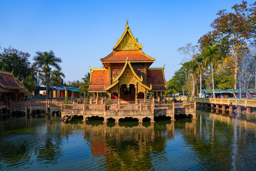 Fototapeta premium Traditional Lanna pavilion reflected in the sacred pond of Wat Phra That Pha Ngao temple in Chiang Saen, Northern Thailand