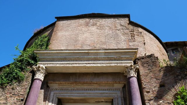 ancient roman brick rotunda facade richly carved marble entablature purple stone columns ivy covered masonry defines tempio del divo romolo reveals upward view rome italy empire 