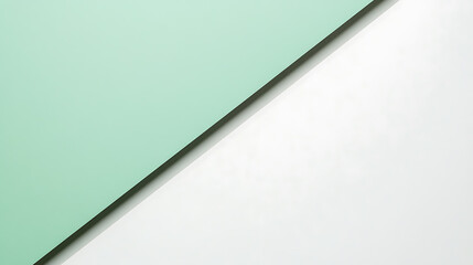 Abstract composition with mint green and white diagonally divided by a shadow line, creating a modern and minimalist aesthetic. Two-tone background, color block.
