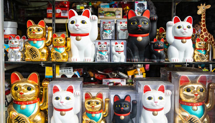 Colorful Manekineko Lucky Cat Figurines On Shelves.
