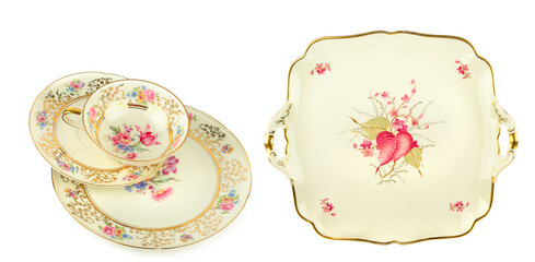Vintage porcelain tea set with floral patterns isolated on white.