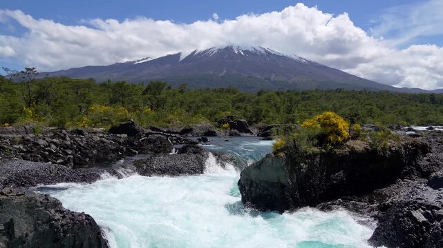 Puerto Varas, Chile: Footage of Petrohue waterfall situated near Puerto Varas in Lake District of Chile with Osorno volcano covered with cloud on sunny day