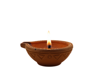 Traditional clay oil lamp with lit flame
