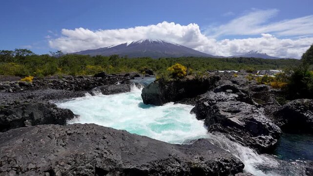Puerto Varas, Chile: Footage of Petrohue waterfall situated near Puerto Varas in Lake District of Chile with Osorno volcano covered with cloud on sunny day