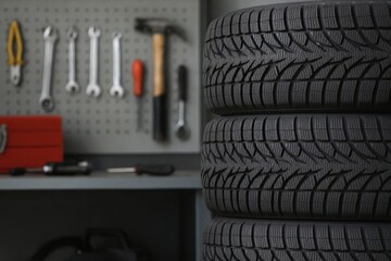 Stacked car tires in auto repair workshop