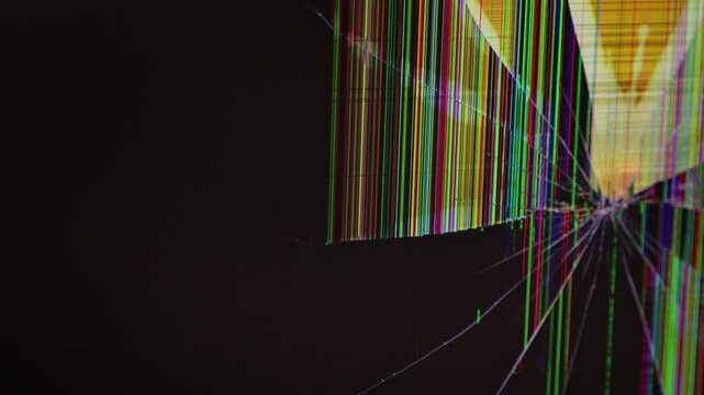 A broken computer monitor's shattered LCD screen displays colorful glitch art and radiating cracks, visualizing critical hardware failure or digital system malfunction. Zoom