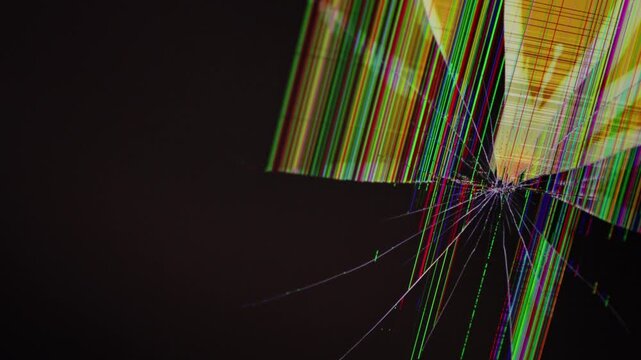 Cracked computer monitor screen with a central impact point showing colorful vertical pixel lines, representing a severe hardware failure and system malfunction