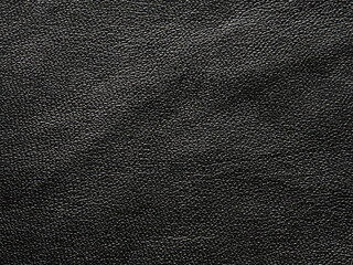 Black leather texture background with high detail pebbled grain material surface for fashion and upholstery design projects.