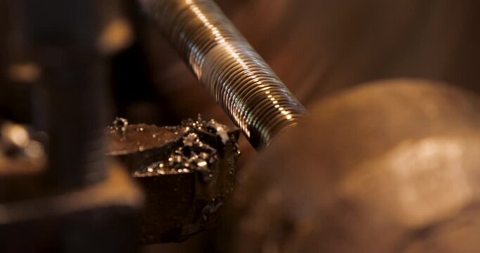 Cutter Cuts Threads on a Spinning Shaft on a Lathe Machine. The Metalworking Process by Turning Machine. Industrial Concept