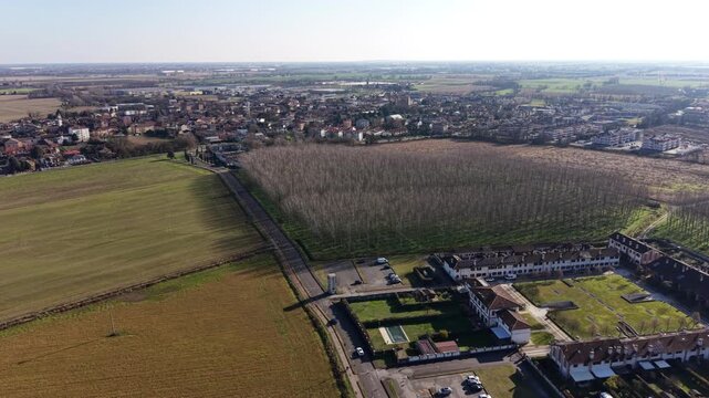 Drone view of the modern Cascina Adelina residential complex and Siziano, Lombardy, Italy.