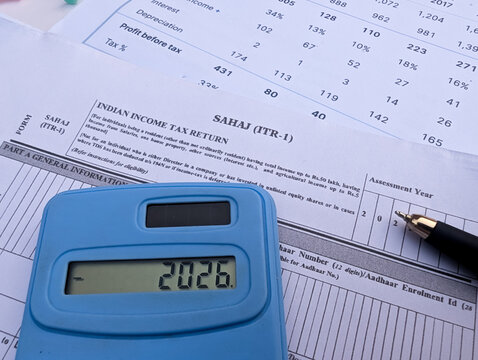 Indian income tax return Sahaj ITR 1 form with blue calculator showing 2026 and pen stock photo