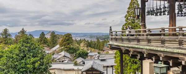 People enjoying the panoramic view from Todai-ji Nigatsu-do temple on top the hill in Nara, Honshu island in Japan