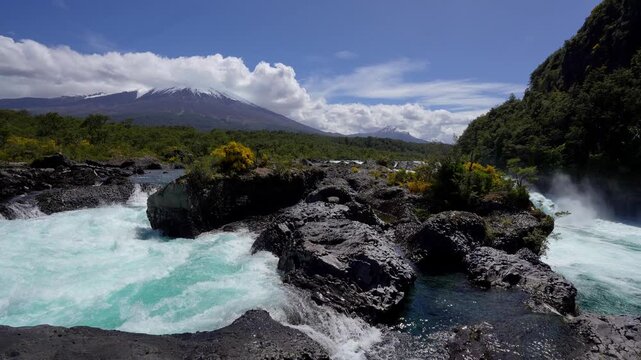 Puerto Varas, Chile: Footage of Petrohue waterfall situated near Puerto Varas in Lake District of Chile with Osorno volcano covered with cloud on sunny day