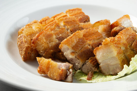 A closeup view of a plate of lechon kawali.