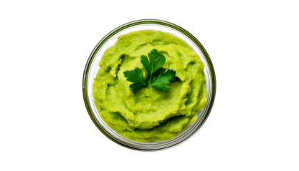 Creamy green guacamole in a clear bowl garnished with a fresh parsley sprig, isolated on a t.png