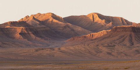 Naklejka premium Hyperrealistic panoramic desert mountains at golden sunset, dramatic layered rocks, sharp ridges, minimalistic flat foreground, warm tones, high-detail, professional photography.