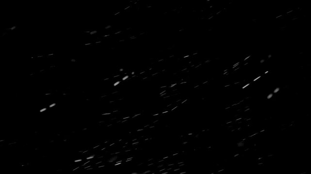slanting snow flies towards the ground and into the sky in motion in the night sky