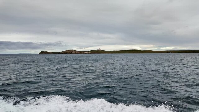 Punta Arenas, Chile: Footage from boat saling to Magdalena Island, national park near Punta Arenas, Patagonia of Chile with lighthouse under cloudy sky