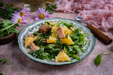 Arugula salad with oranges on a beautiful plate for breakfast. A vegetarian dish. Close-up