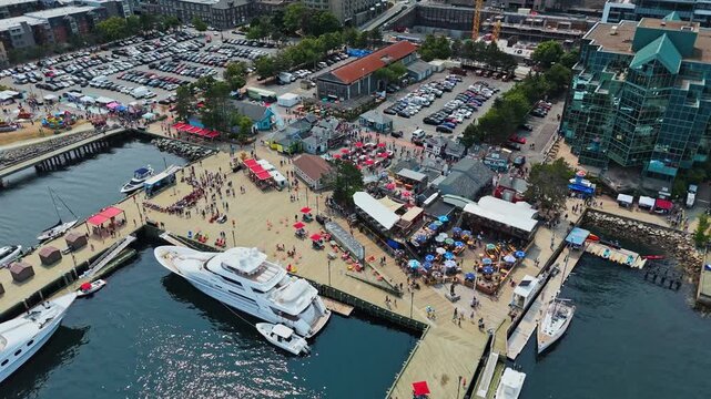 Drone View Captures Halifax Nova Scotia Canada With Modern Skyscrapers A Busy Waterfront Yachts In The Harbor And Tourists Enjoying A Warm Summer Day In The Vibrant Coastal City
