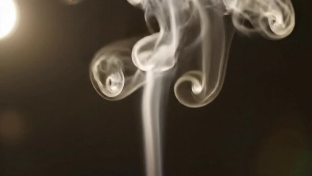Ethereal white smoke column gracefully rising and swirling in slow motion against a dark background for meditation and atmospheric design concept