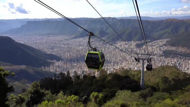 This breathtaking video captures a stunning cable car ride high above a vast cityscape. With panoramic views of the mountains and urban sprawl, the experience offers a thrilling blend of nature and ci