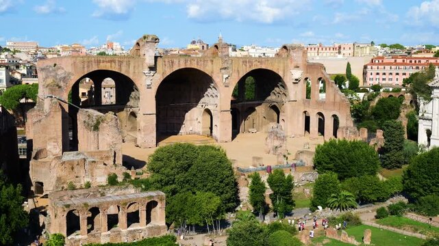 sunlit basilica maxentius constantine monumental brick arches above green gardens visitors stroll through rome close view italy roman empire emperor of 
