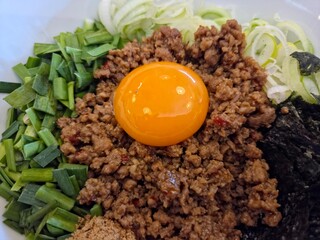 Close-up of Japanese Nagoya Mazesoba (or Taiwan Mazesoba), brothless Japanese ramen, featuring a...