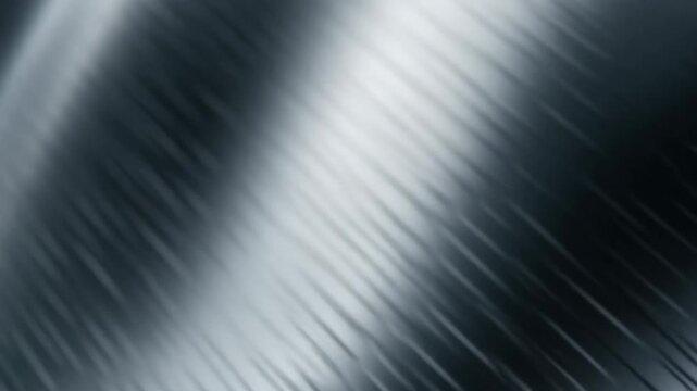 A reflective metal surface set against a solid black background, highlighting its shine and texture.