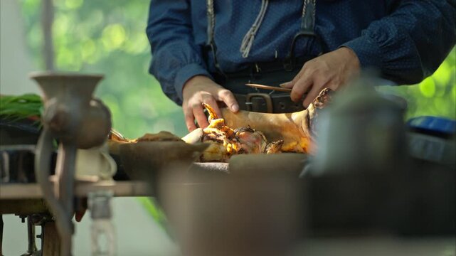 Cowboys gather around a chuck wagon preparing fresh ingredients for cooking
