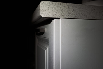 Minimalist kitchen countertop and cabinet with modern design in dim lighting. © elenavolf