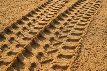 Deep tire tracks in soft yellow sand