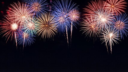 Obraz premium Vibrant fireworks explode in the night sky during a festive celebration