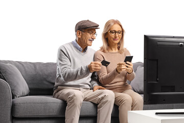Mature couple shopping online with a smartphone and a credit card