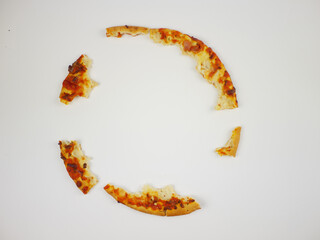 Scattered Pizza Crust Leftovers Arranged in Loose Circle on White Background Illustrating Food Waste and Consumption Theme