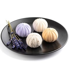 A sleek black plate showcases three vibrant bath bombs: a lavender swirl, a citrus burst, and a calming ocean blue, each uniquely textured and inviting.
