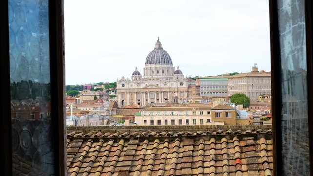 framed window across terracotta rooftops leads st peter basilica rome grand dome rises under overcast sky castel sant'angelo toward view italy roman empire emperor 