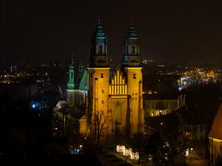 Fototapeta premium Aerial drone view of Cathedral Basilica of Saints Peter and Paul in Poznan in. Ostrow Tumski at night