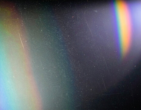 Abstract light leak background with soft rainbow prism flare and subtle film grain texture. Minimal atmospheric backdrop for retro-style design, creative layouts, posters, and modern visuals 