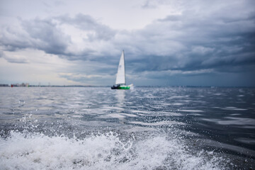 splashing water from under the rubber boat in stormy weather, sailing regatta in the Gulf of...
