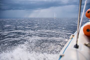 splashing water from under the rubber boat in stormy weather, sailing regatta in the Gulf of...