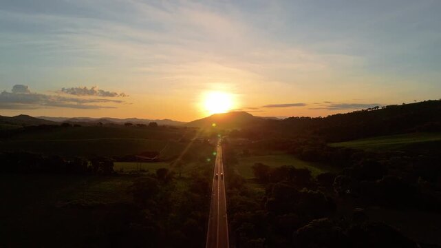 tr&acirc;nsito na rodovia com Bel&iacute;ssimo p&ocirc;r do sol na estrada
