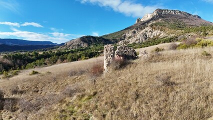 Winter aerial drone view of the ruins of a castle in the mountains of Sigottier, Hautes-Alpes,...