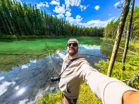 Photographer taking selfie at herbert lake in banff national park