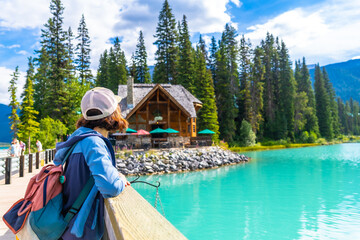 Tourist admiring emerald lake and the lodge in banff national park, canada